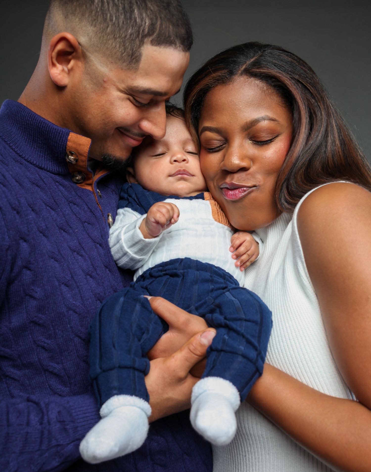 A family shares tender moments in a series of intimate black and white photographs showing closeness and affection.