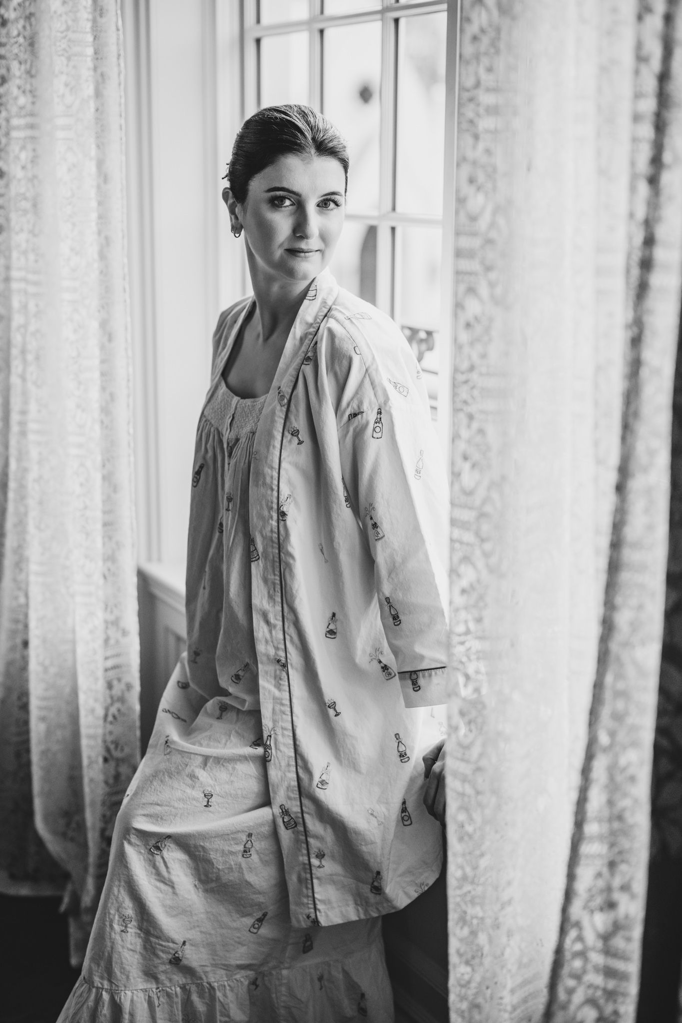 Black and white portrait showing someone wearing a casual denim jacket in a bright interior setting.