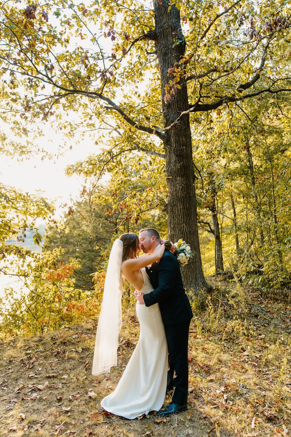 Bride and Groom couple's portraits with groom kissing the bride at The Venue On Lake Grant in Mt. Orab Ohio: Cincinnati wedding photographer