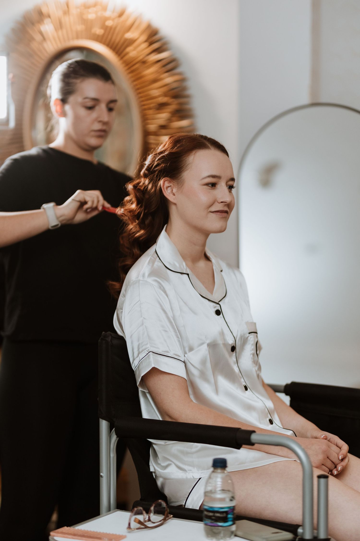 Bride having hair done morning of wedding at Crewe hall.