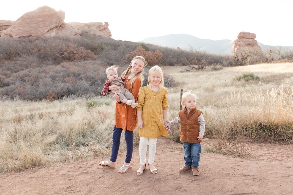 Group photos taken against scenic red rock formations and desert landscape.