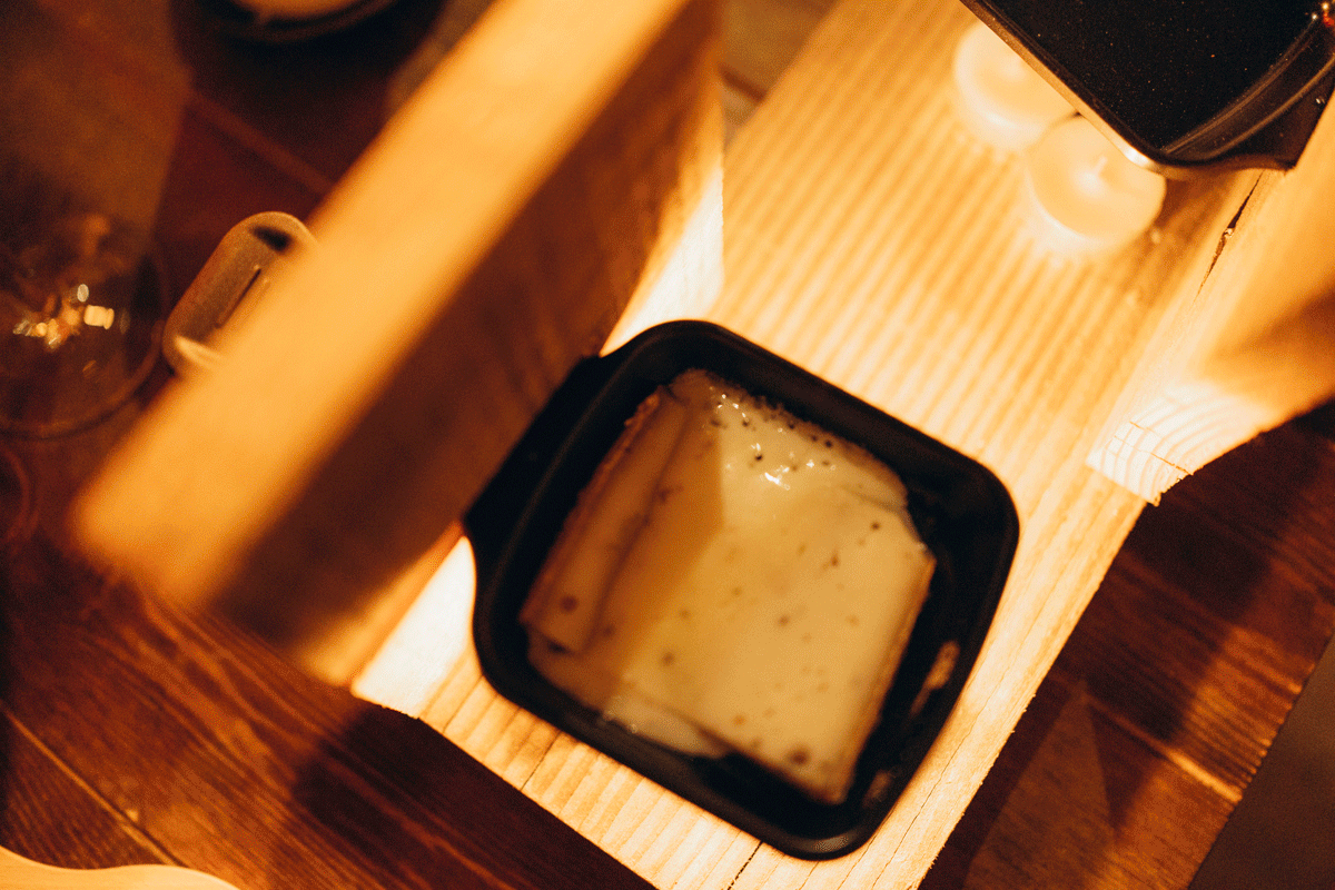 Close-up sequence of coffee being brewed through an espresso machine with rich crema dripping into a dark cup.