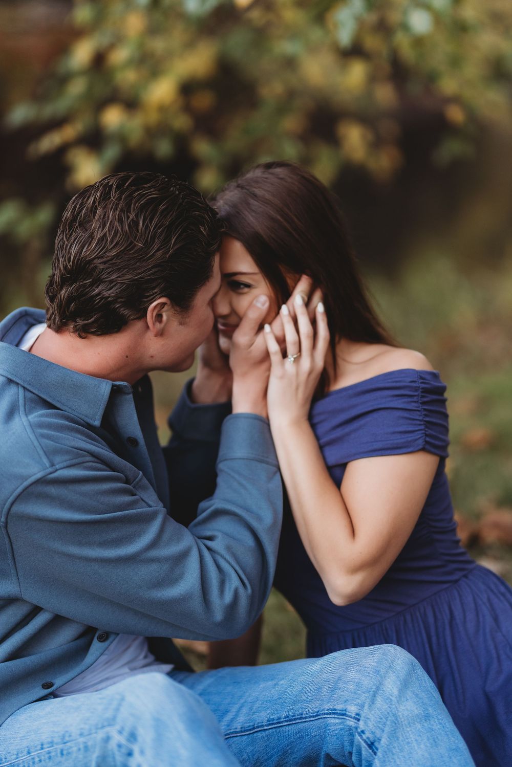 An intimate couple shares emotional moments in a natural outdoor setting.