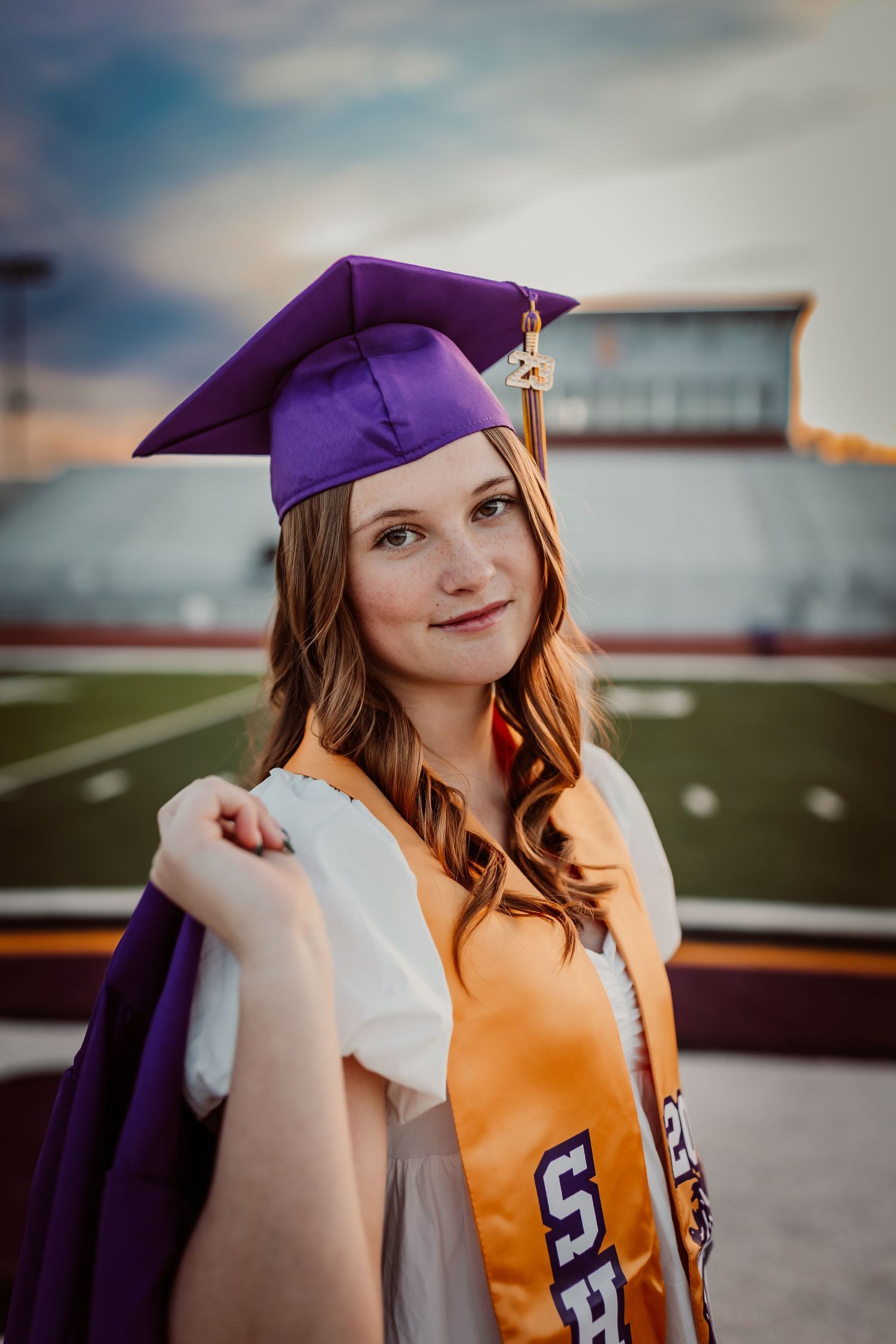 Senior graduation portrait in Kansas featuring cap and gown and confident posing