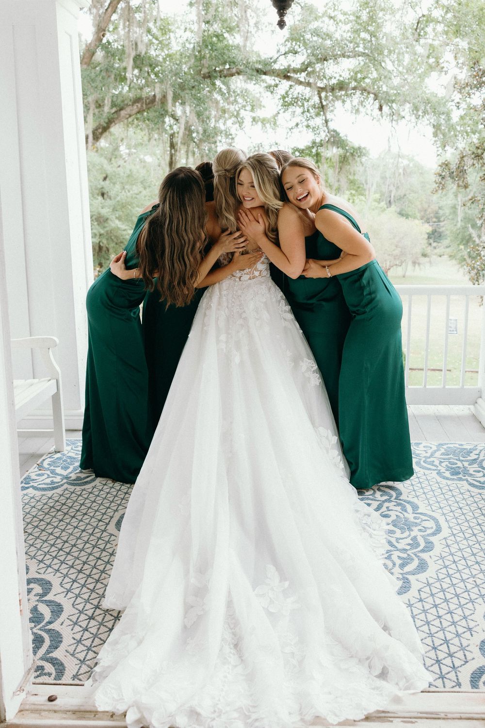 Bride hugging her bridesmaids before the wedding ceremony at The Elms of Coosada in Coosada, Alabama