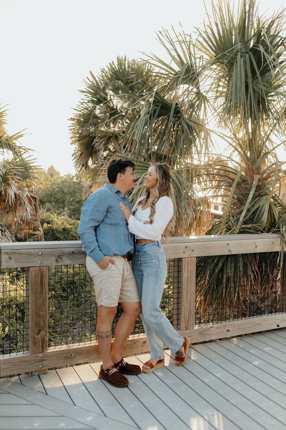 Couple standing together on a boardwalk during a lifestyle couples photography session.