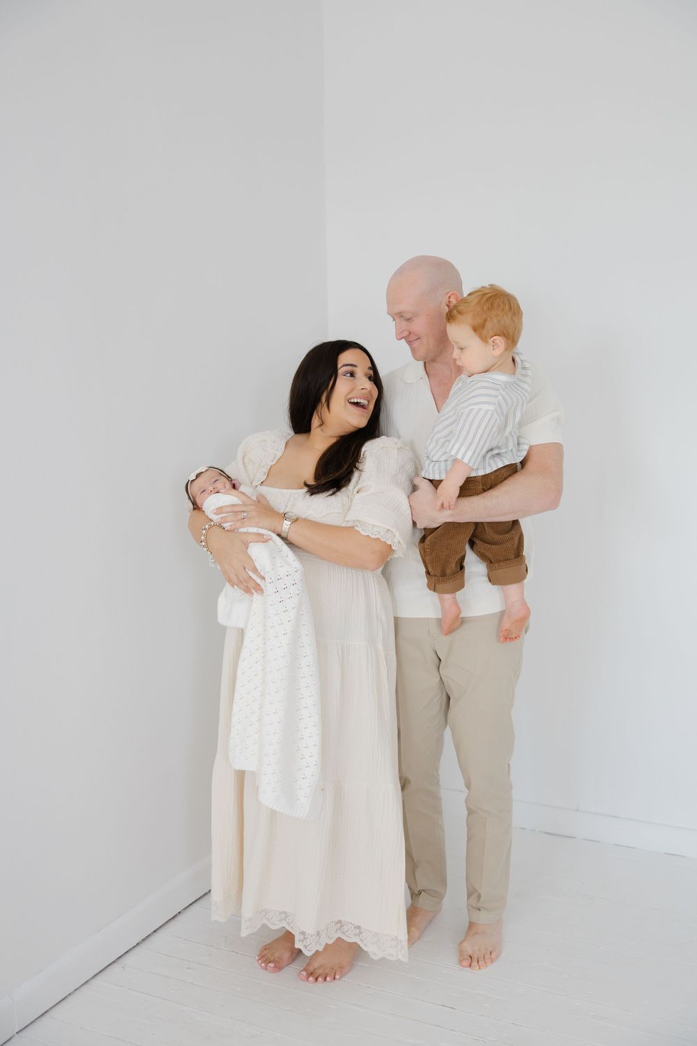 Parents holding their baby during a studio lifestyle family photography session.