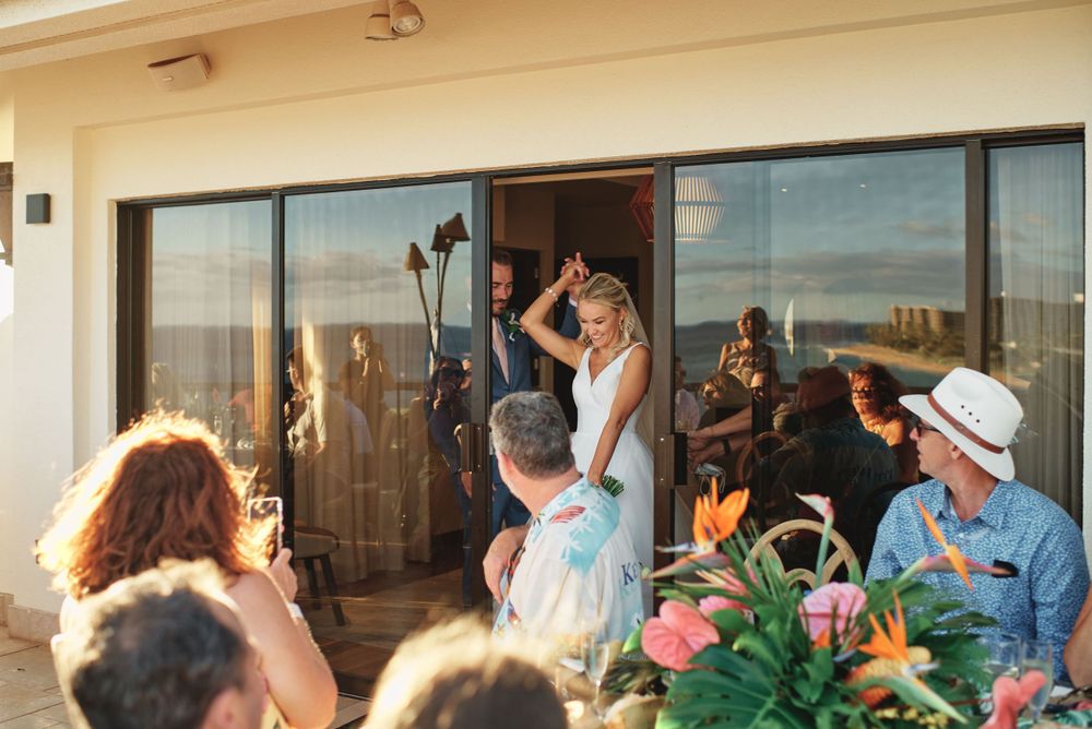 Wedding reception celebration with guests dancing on outdoor patio.