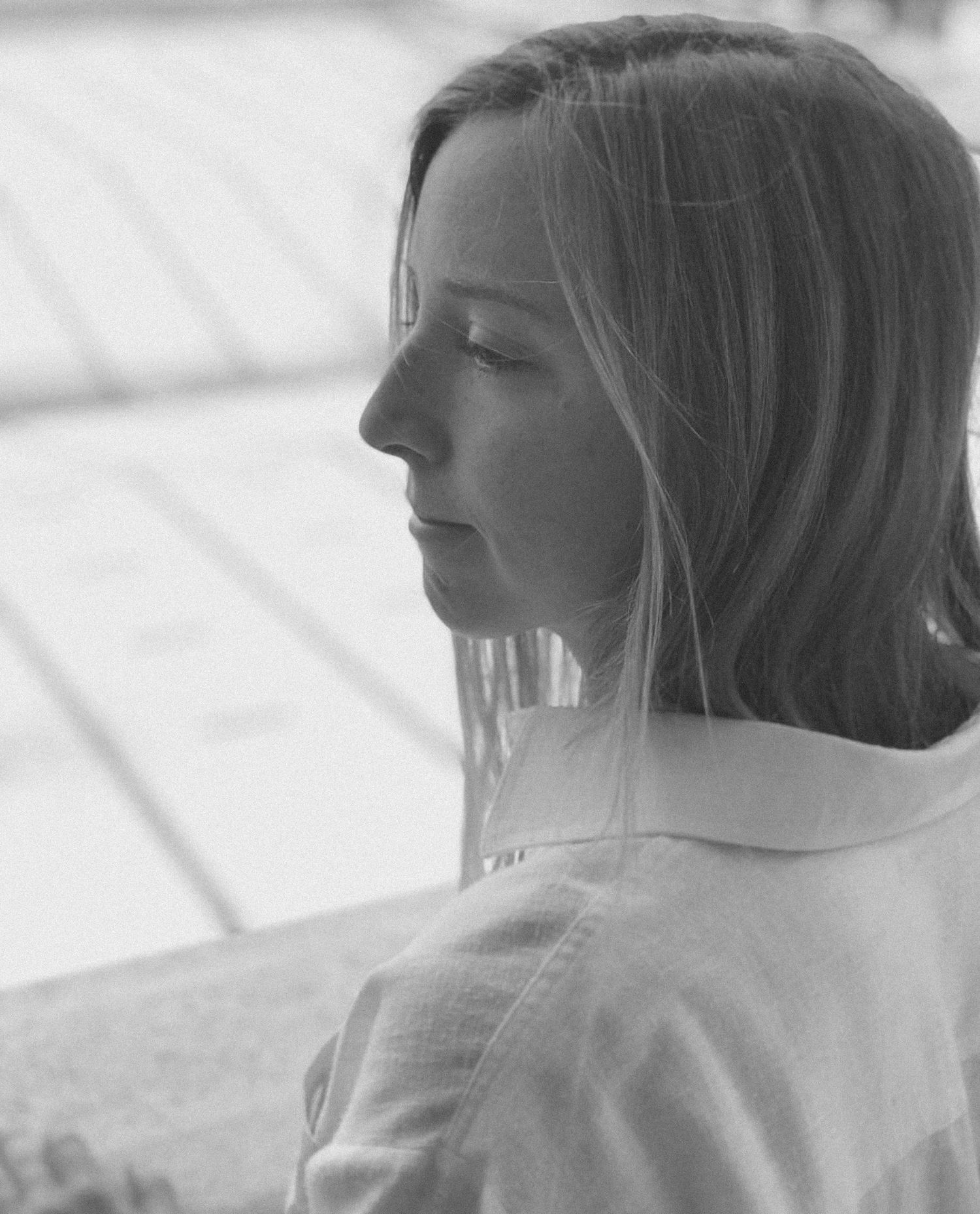 A series of black and white profile portraits showing the same subject from different angles in soft lighting.