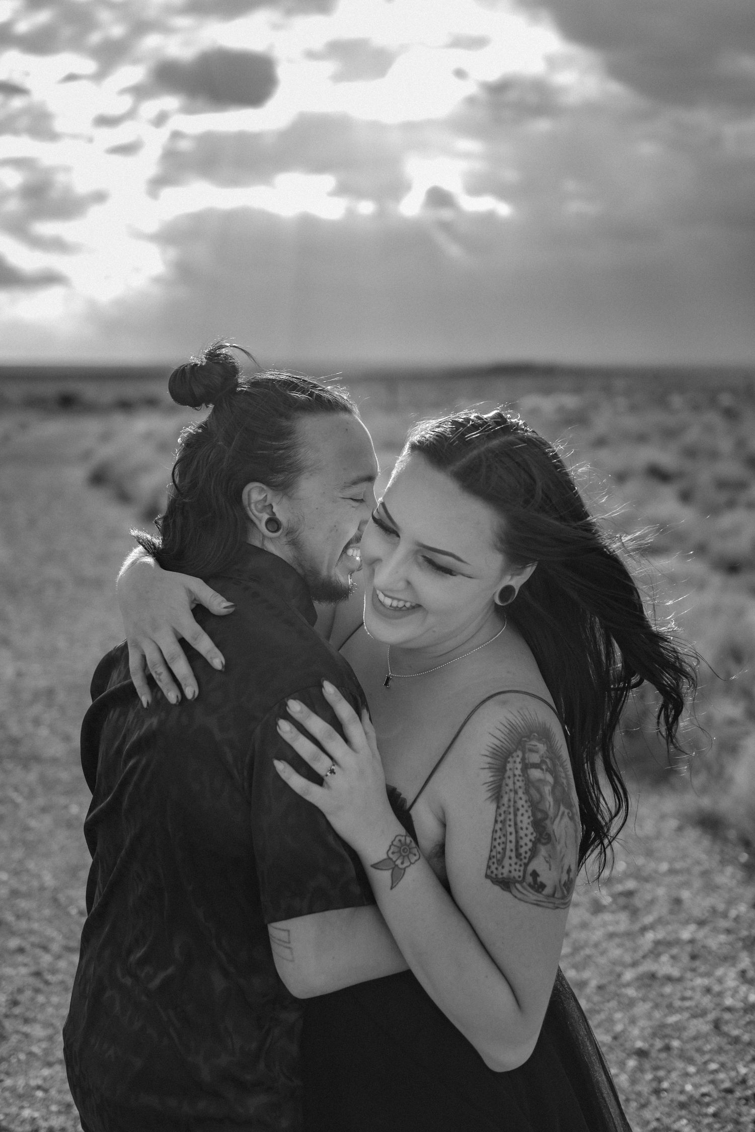 Black and white photo of a joyful embrace between two people sharing a tender moment. Albuquerque engagement photographer. LGBT wedding abq.