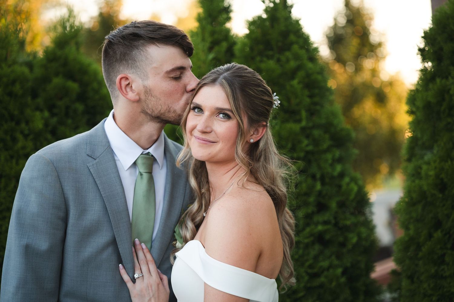 Wedding portrait couple during golden hour surrounded by greenery on patio of The Barn at Villa Venezia in Middletown, NY.