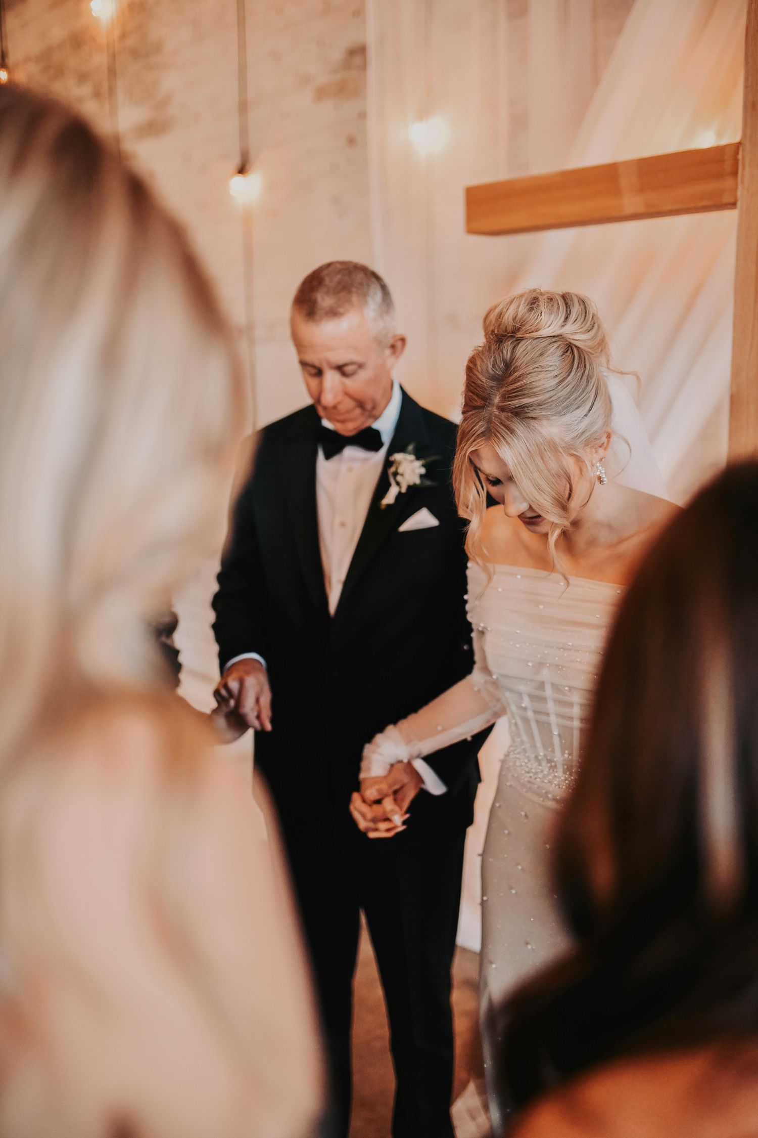 Sweet, tear-filled first look between bride and parents inside the industrial-chic Brake & Clutch Warehouse wedding venue.