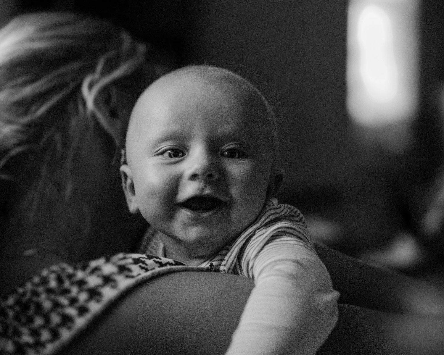 Close-up black and white portrait sequence showing tender moments between parent and baby.