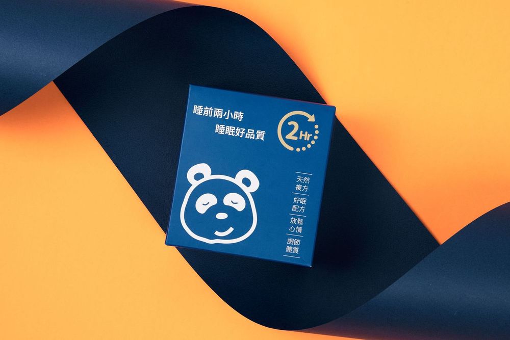 Navy blue business card with panda logo design against orange background creates modern brand identity.