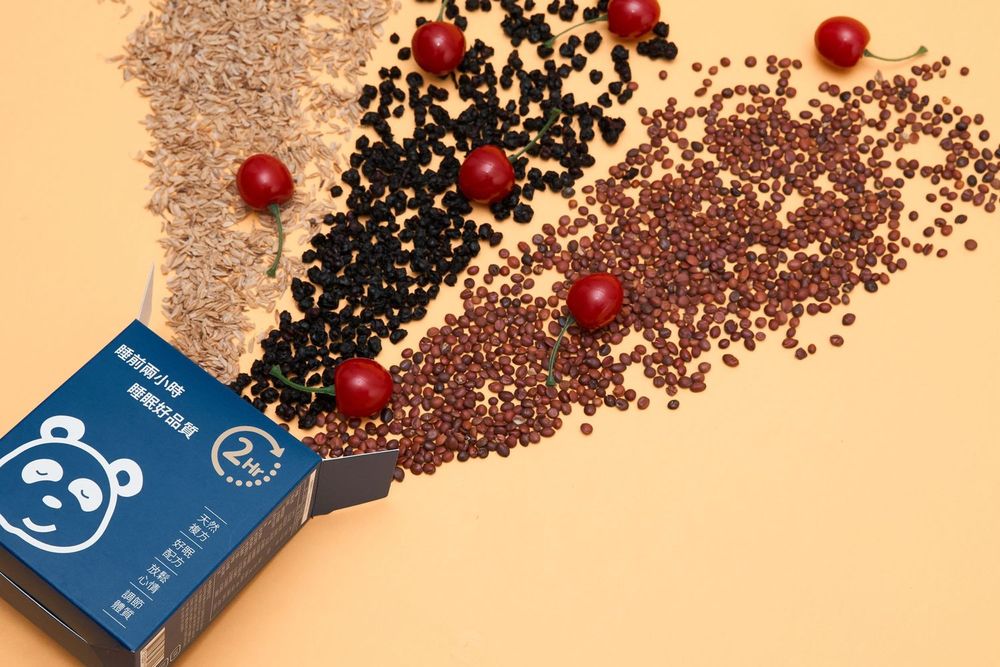 Blue credit cards displayed with scattered coffee beans and red berries on beige surface.