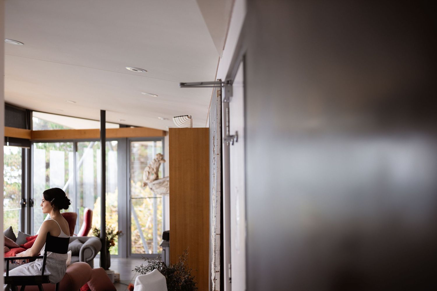 Modern office space with glass walls and natural light streaming through large windows.
