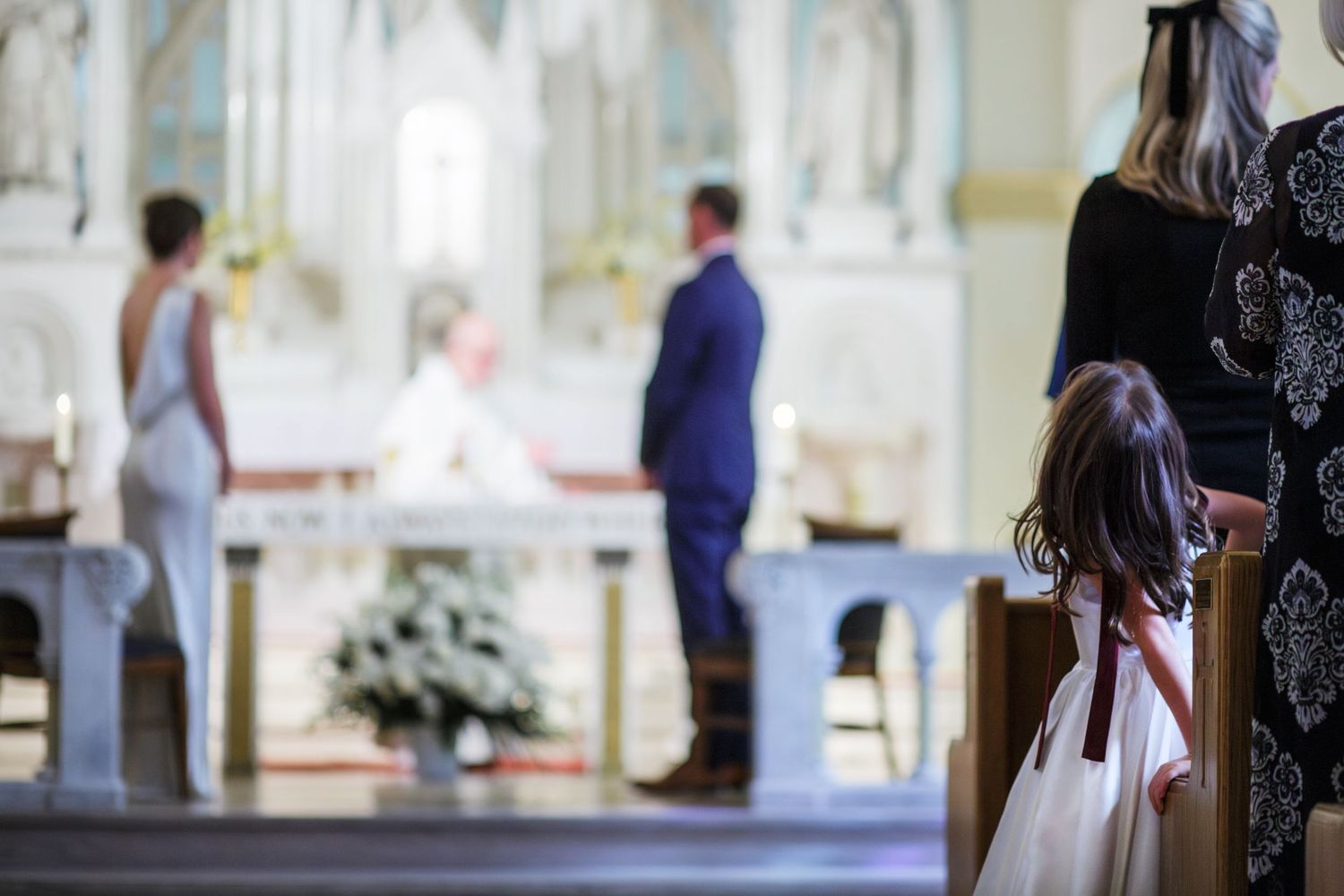 Flower girl watches the Bride and Groom exchange their vows.
