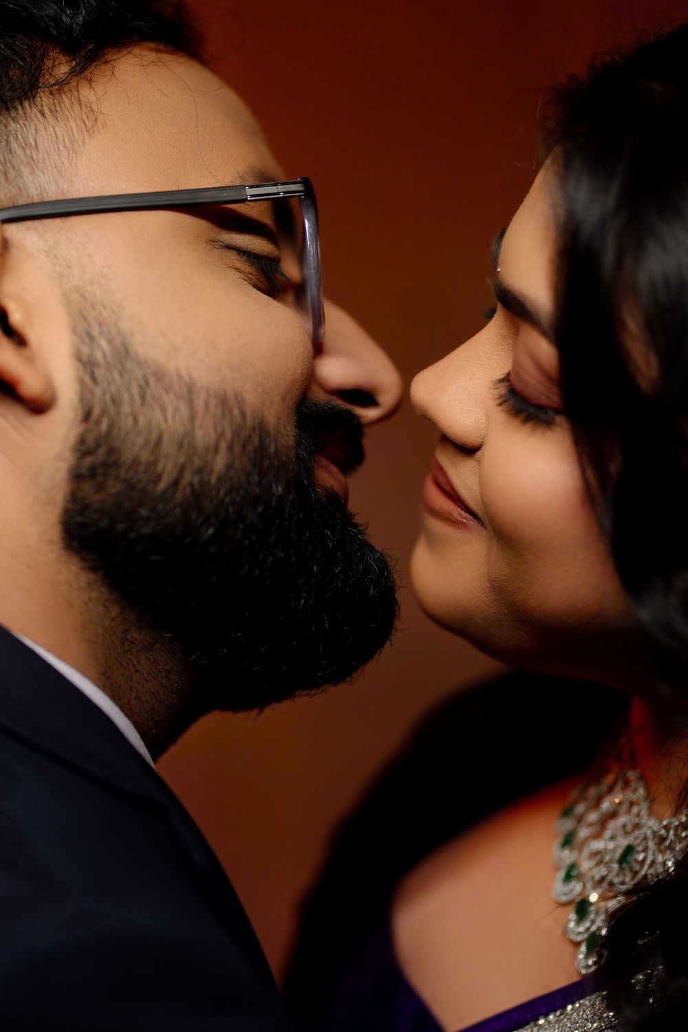 A romantic close-up sequence shows an intimate moment between a couple in formal attire against a dark background.