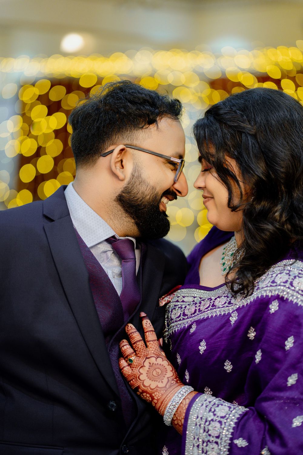 A romantic moment captured in a series of photos showing a couple in traditional Indian wedding attire with purple and gold decor.