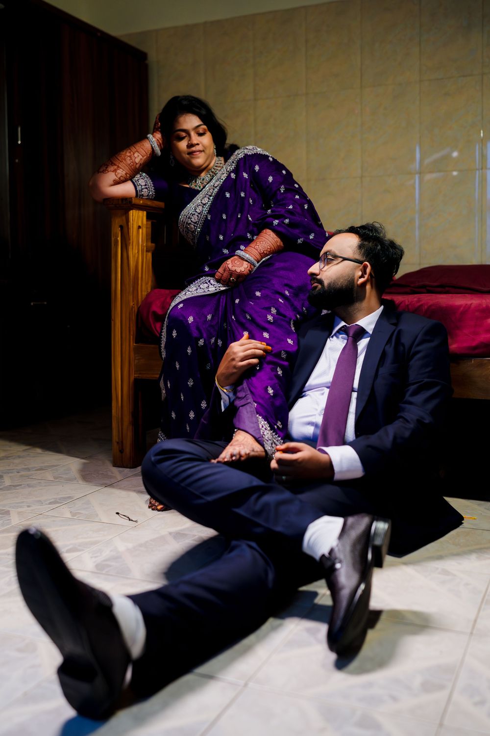 A person in a dark suit reclines on a light-colored floor in a progressive sequence of images.