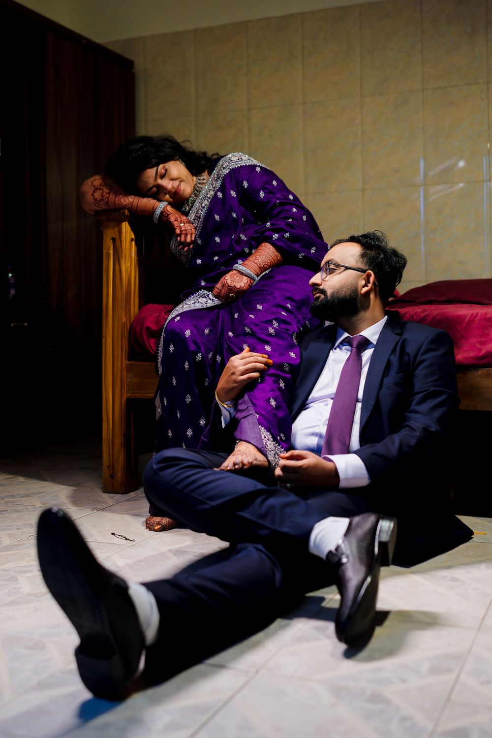 A sequence of photos showing a person in a suit and purple shirt falling backwards on a floor in a dramatic fashion.