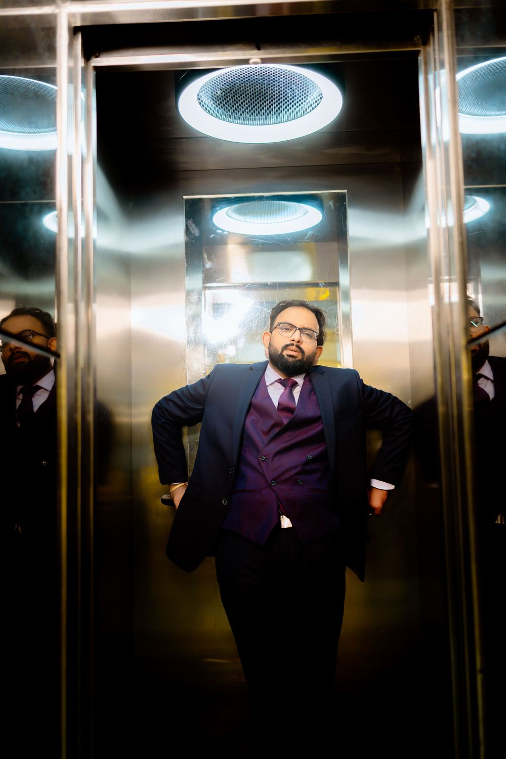 A sequence of elevator interior shots showing a person in a purple suit leaning against the metallic walls.