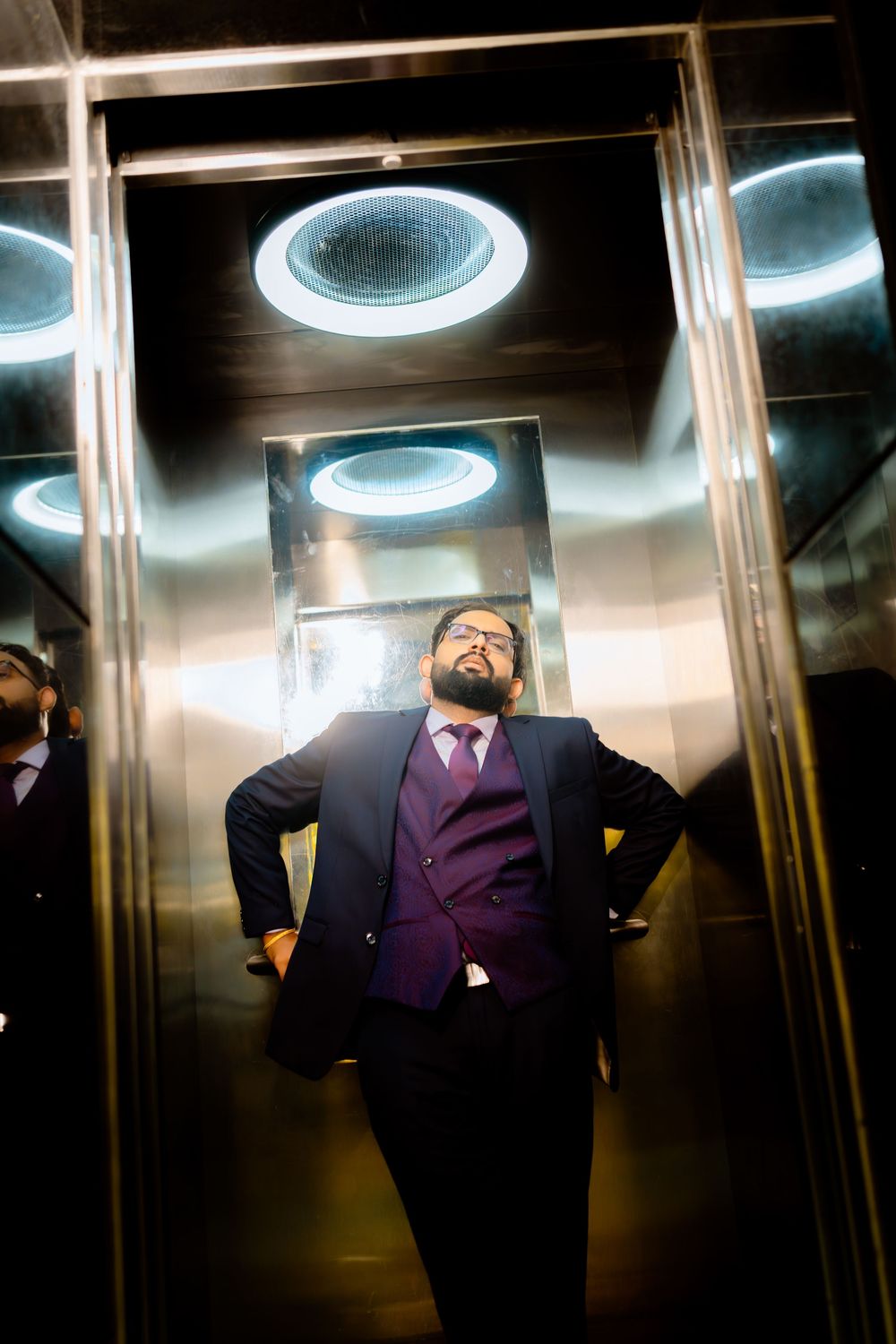 A sequence of photos showing a person in a purple suit moving and dancing inside a mirrored elevator.