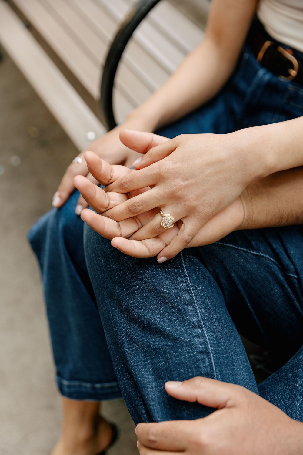 Close-up sequence of hands clasped together on denim jeans showing intimacy and connection.