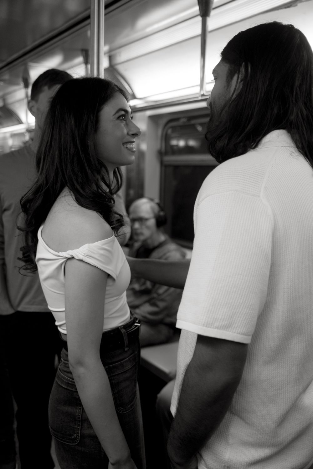 A couple shares an intimate moment while riding public transit together.