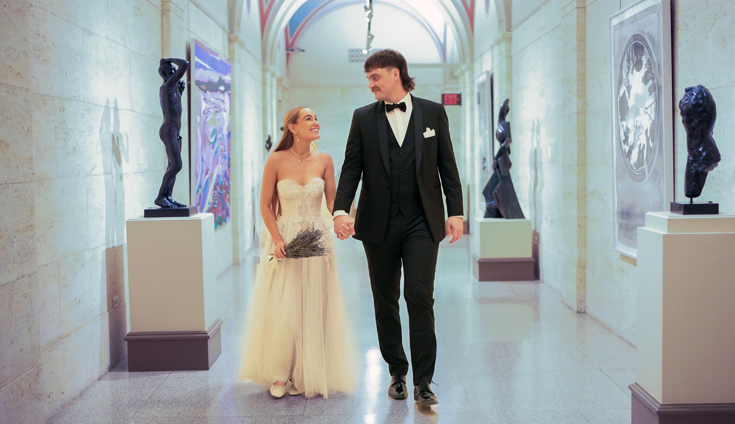 A newlywed  walks down an elegant hallway in Columbus Museum Of Art