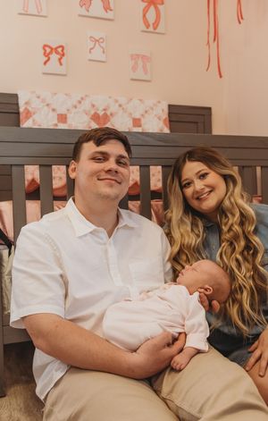 Intimate family portrait showing loving interaction in a nursery setting.