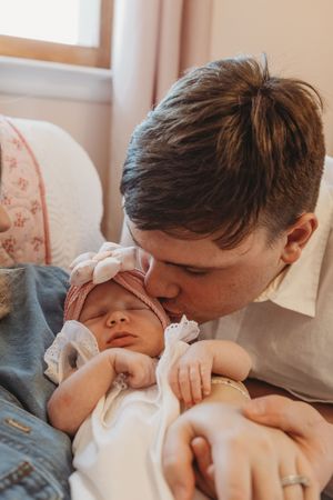Intimate black and white photos showing tender moments between parent and baby.