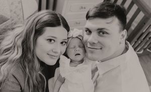 Black and white family photos capturing tender moments with an infant.