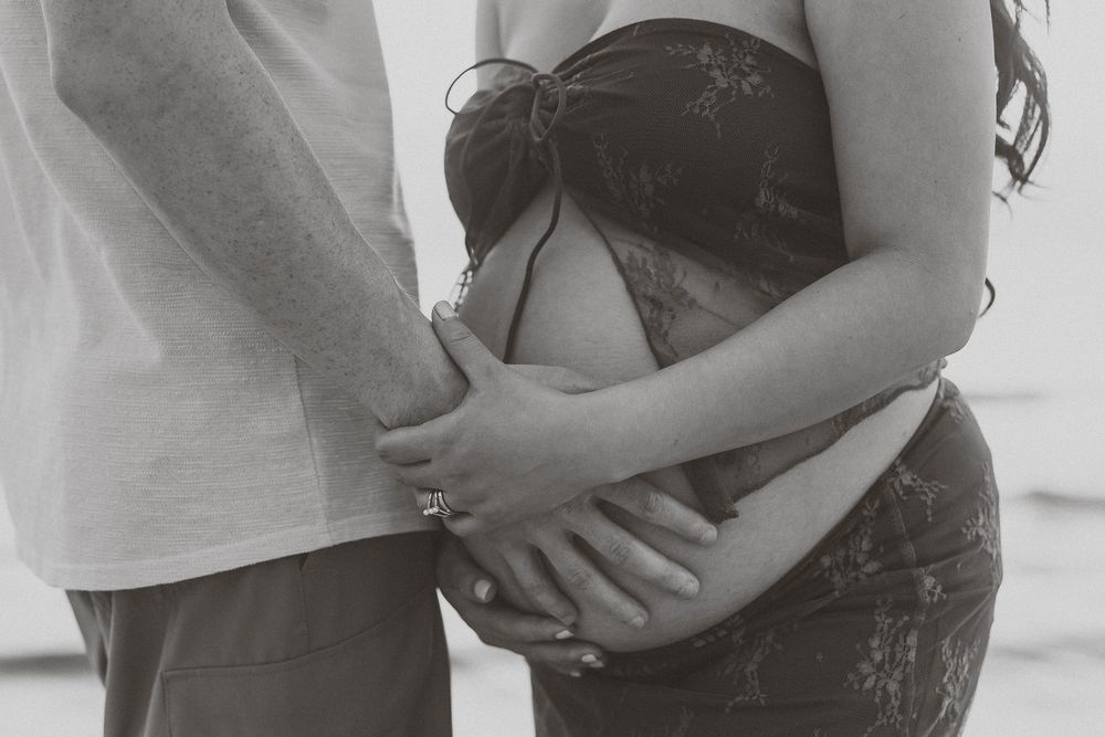Black and white photo series showing close-up details of an intimate embrace between two people.