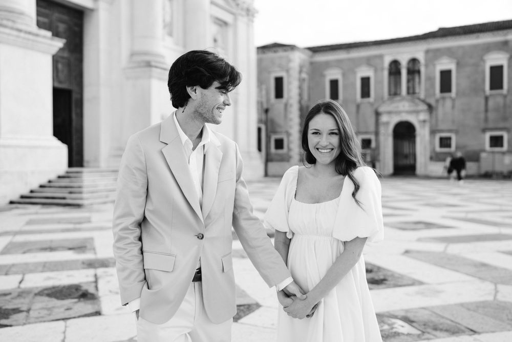 A series of black and white wedding photos showing a couple in formal attire outside a grand building.