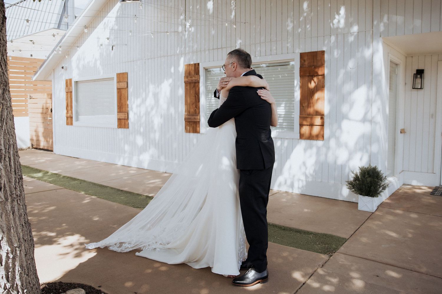 A series of wedding dress displays in a bridal boutique with natural light streaming through windows.