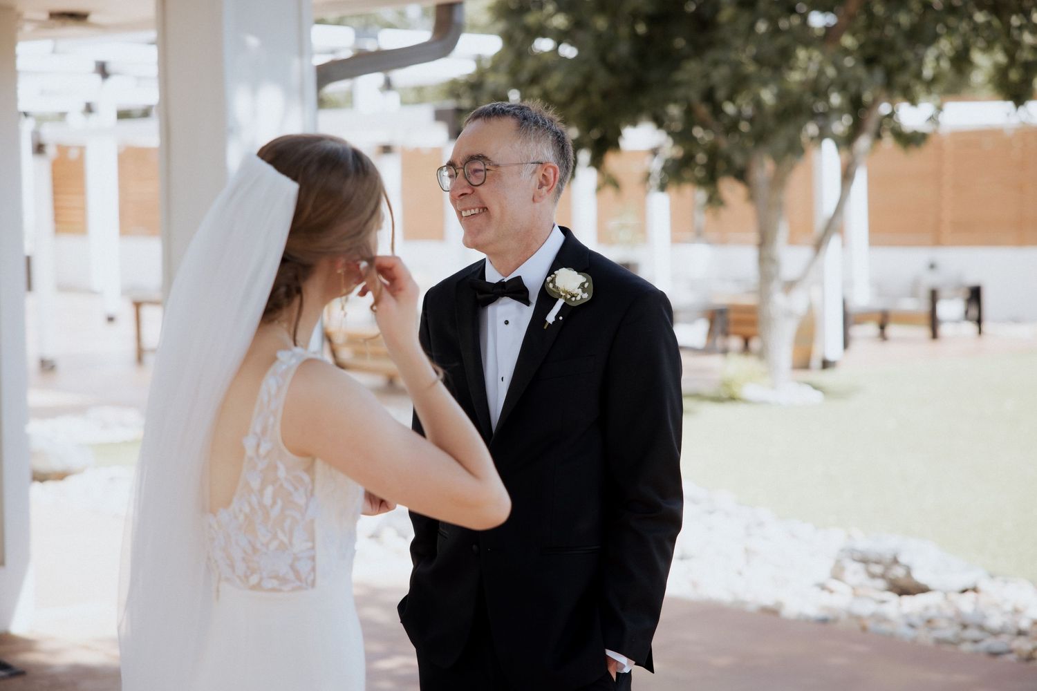 A bride and groom share an intimate moment together during their outdoor wedding ceremony.