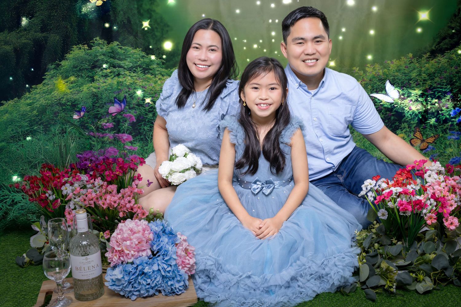 Elegant blue floral photoshoot in a garden with hydrangeas and decorative flowers.