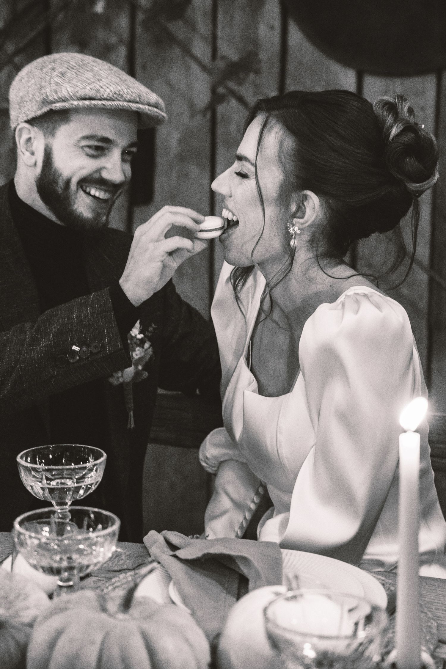 Black and white candid moments of people dining and laughing at an elegant table setting.