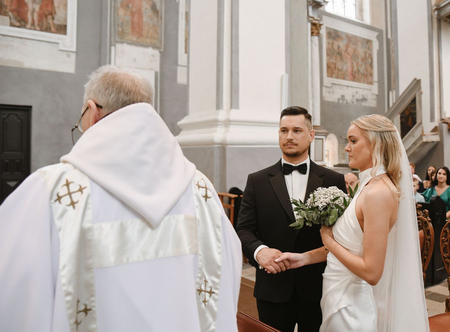 Wedding ceremony moments captured in a church with elegant decor and traditional architecture.