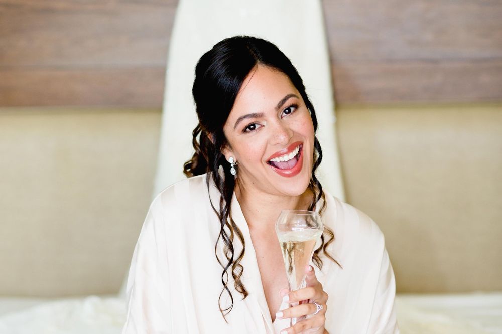 A bride in a white wedding dress and veil poses joyfully in a series of candid portrait shots.