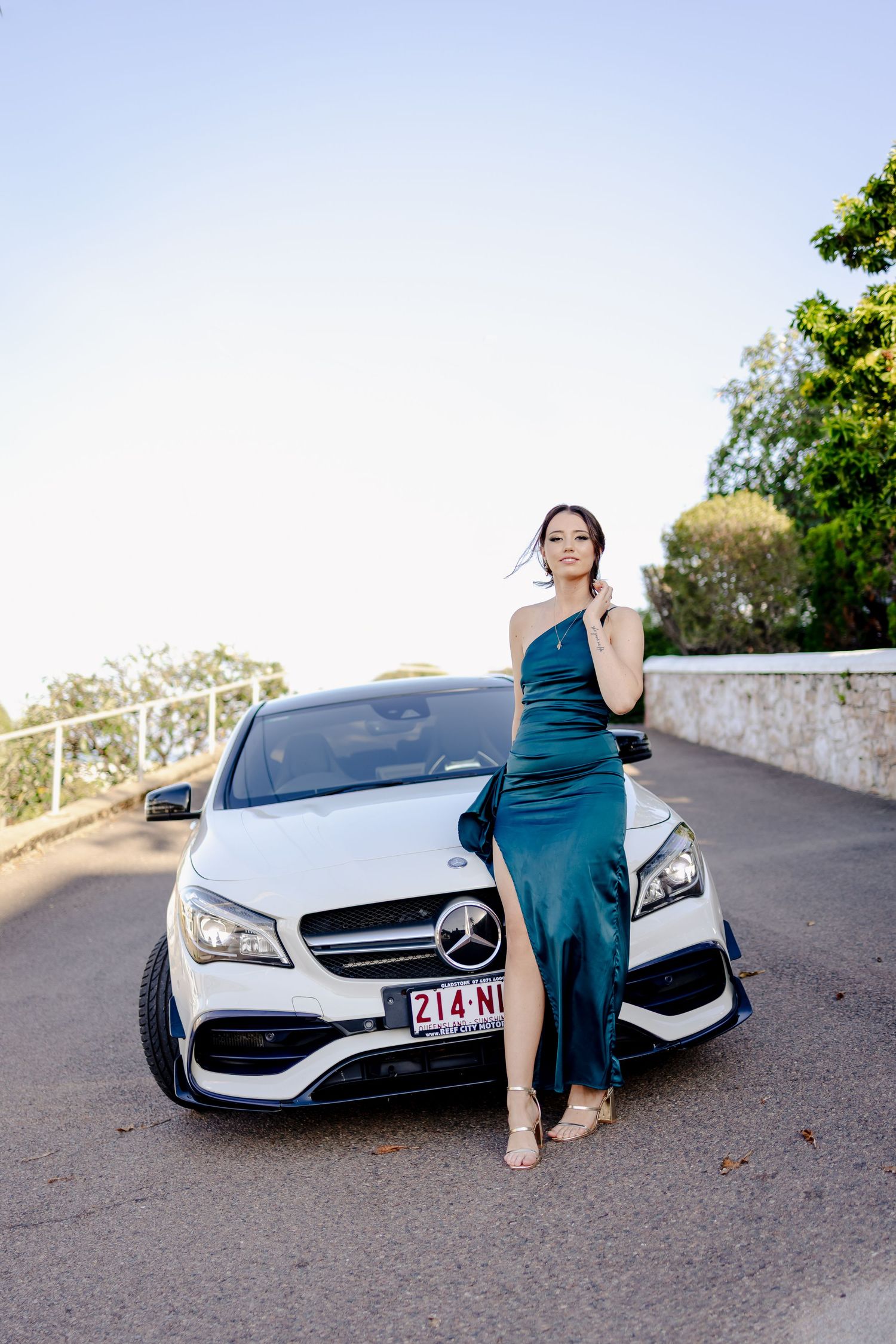 A series of glamour shots featuring a teal dress alongside a white luxury car.