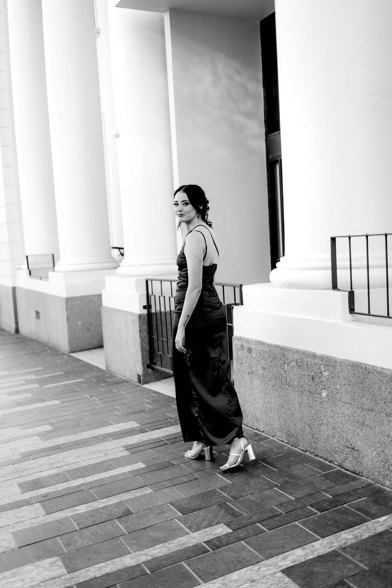 Black and white photo series showing a woman in a dark dress sitting on a porch with white columns.