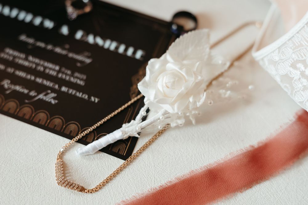 Elegant pearl necklace displayed on a white surface with jewelry cards and packaging materials in the background.