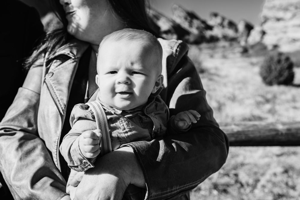 A series of black and white candid photographs showing children playing and smiling outdoors.
