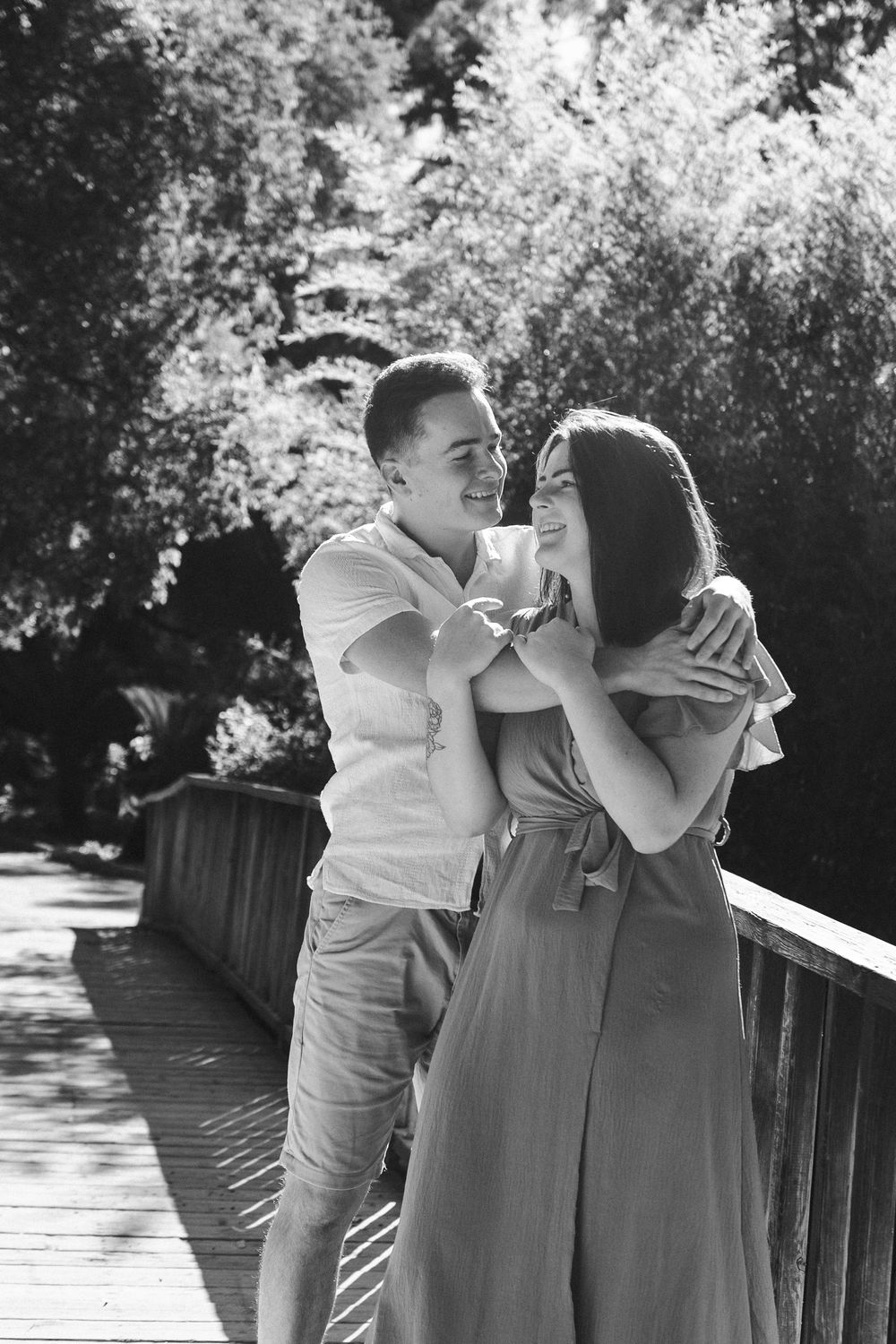 A romantic black and white photo sequence shows a couple sharing tender moments on a sunlit deck.