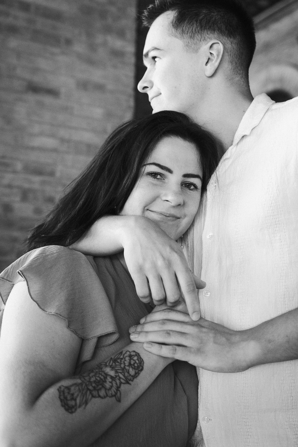 A romantic black and white photo series showing a couple embracing in intimate close-up shots.