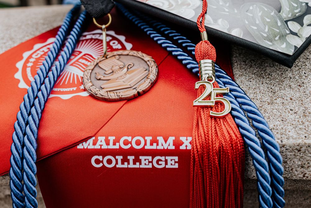 Red graduation stoles with blue honor cords and academic medals on display.