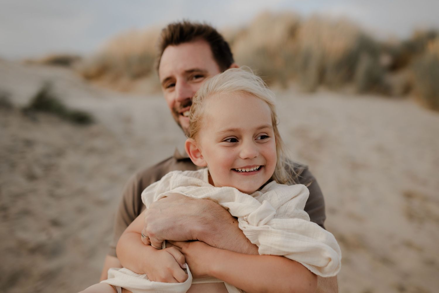 A father and daughter laughing while he is twirling her around kent family photographer