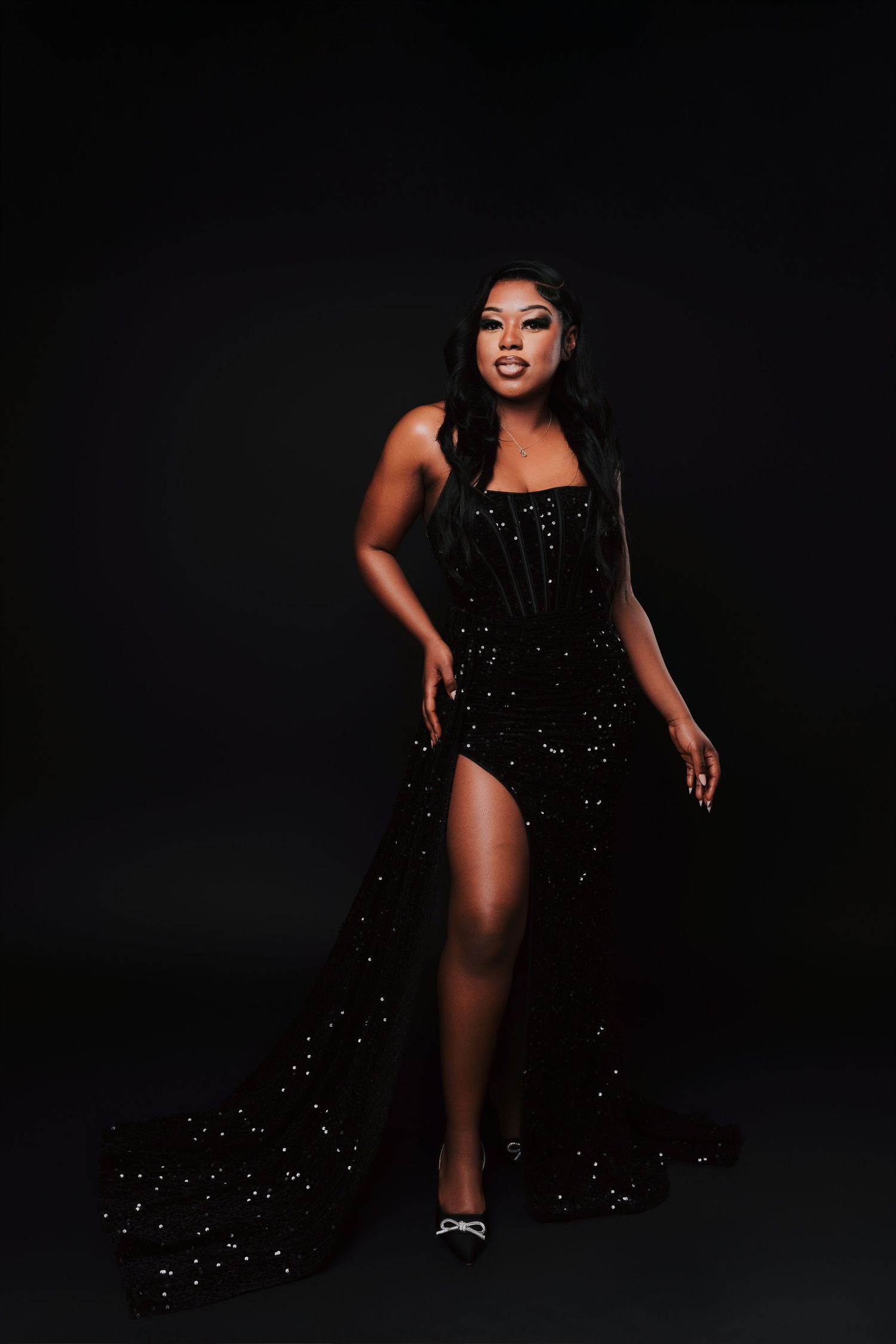 A glamorous photo series showing a model in a sparkling black dress posing dramatically against a dark background.